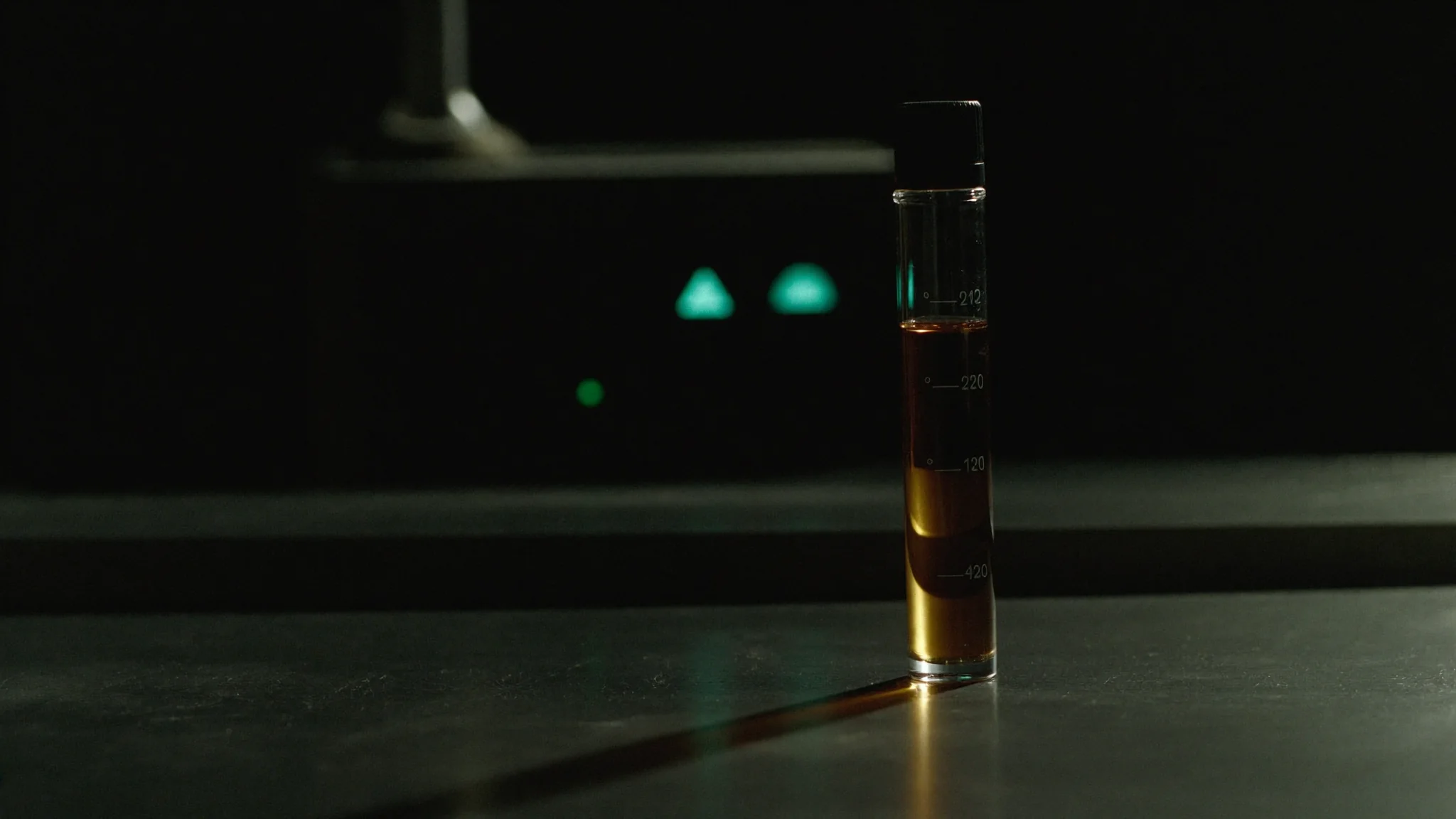 A control sample of jet fuel in a measuring cylinder on a laboratory bench
